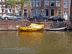 Wooden Shoe-Shaped Boat on an Amsterdam Canal, Netherlands photo